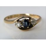 An 18ct sapphire and diamond crossover ring, size Q, 2.9g