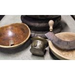 A 19th century or possibly earlier shallow brass bowl/basin with flared rim, two treen bowls, bronze