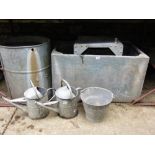 A collection of galvanized iron including two water tanks, a water tub, two traditional watering