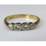 An 18ct four stone diamond ring, size I/J, 1.7g