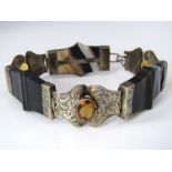 A Scottish agate bracelet with engraved silver links each set with a faceted citrine, 19.3cm long