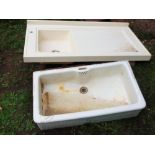 A reclaimed white glazed butlers sink together with a further composite sink and combined draining