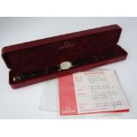 A ladies 18ct quartz Omega wrist watch, with leather strap, box and papers