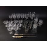 A mixed collection of etched glasses and goblets, together with a further glass vessel with sterling