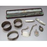 A collection of bijouterie silver to include two folding pearl fruit knives, two silver medals,