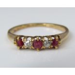 An 18ct ruby and diamond five stone ring, size N, 2.4g