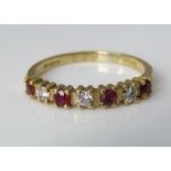 An 18ct ring set with alternating diamonds and rubies, size L/M, 2g