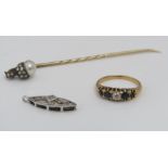 A Victorian gold articulated stick pin in the form of an acorn, set with rose cut diamonds and a