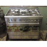 A Smeg five ring freestanding range cooker with gas hob and brushed chrome finish, 90cm long x