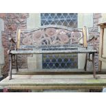 A weathered cast iron and timber lathe garden bench, the back panel incorporating a cast iron