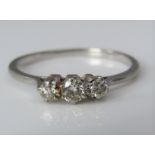 A platinum three stone diamond ring, largest diamond 0.10cts approx, size K, 1.9g