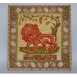 Antique wool work picture of a standing lion, inscribed Isabella Kendall - aged XIII years, framed