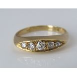 A graduated five stone diamond ring, indistinctly marked, size L/M, 4.3g