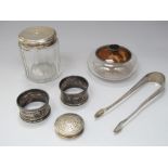 A mixed collection of silver to include a pair of bright cut silver sugar nips, two napkin rings,