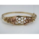 A boxed 9ct Clogau hinged bangle of hexagonal floral design with applied rose gold bees, 16g