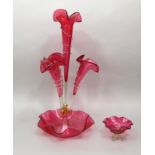 A 19th century cranberry glass eupergne, the central trumpet framed by three further scrolled