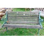 A small garden bench with cast iron ends and timber lathes