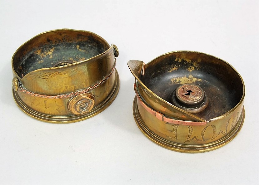 An interesting pair of brass trench art lanterns in the form of captains helmets, one inscribed E