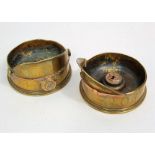 An interesting pair of brass trench art lanterns in the form of captains helmets, one inscribed E