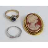 A 9ct sapphire and diamond cluster ring, size N, together with a 9ct mounted cameo brooch