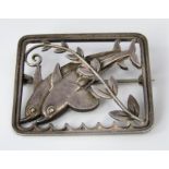 A Georg Jensen sterling silver rectangular brooch depicting two leaping dolphins, no.251, 3.9 x 3.