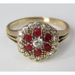 A 14k diamond and ruby cluster ring stamped KGJ, size M/N, 3.2g