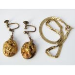A pair of 22ct drop earrings depicting a Buddhistic deity, stamped ORR 22 to reverse, together