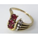 A vintage 14ct ring set with rubies and diamonds in stylised mount, size O, 4.2g