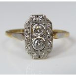 An art deco diamond ring, the openwork plaque with millegrain decoration, central pair of diamonds