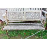 A small garden bench with iron work ends and timber lathes
