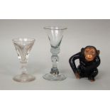An antique cordial glass, with shaped stem, together with a further cordial glass and ceramic