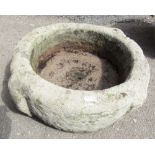 An ancient stone font of circular form with two lug handles, 50cm max