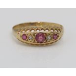 An 18ct pink ruby and diamond ring with pierced gallery, size O, 2.2g