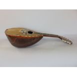 A cased bowl back mandolin, inlaid with a mother of pearl and abalone shell butterfly (af)