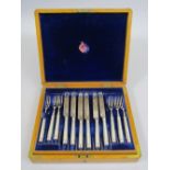 Attractive oak cased two tier canteen of mother of pearl and silver cutlery, comprising twelve