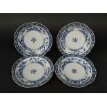 A set of four Chinese porcelain plates, decorated with foliage with polychrome highlights, with