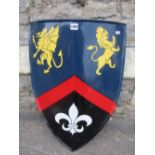 A replica armorial shield with brightly painted finish