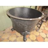 An old cast iron copper with flared rim raised on later associated claw and ball feet, 65 cm