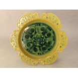 A John French Arklow studio pottery green ground dish with shaped outline and stylised floral