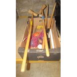 A contemporary croquet set comprising four beechwood mallets, seven simple wire hoops, various