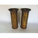 A pair of planished brass trench art vases, one inscribed to base DOD 1916, 28cm high (2)