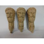 Three carved wooden bosses, each in the form of a bearded gentleman's face, 20cm long (3)