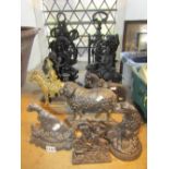 A collection of cast iron door porters to include examples in the form of Punch & Judy, cherub and