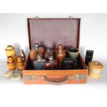 A suitcase containing a collection of flasks and bottles to include silver plated examples, treen