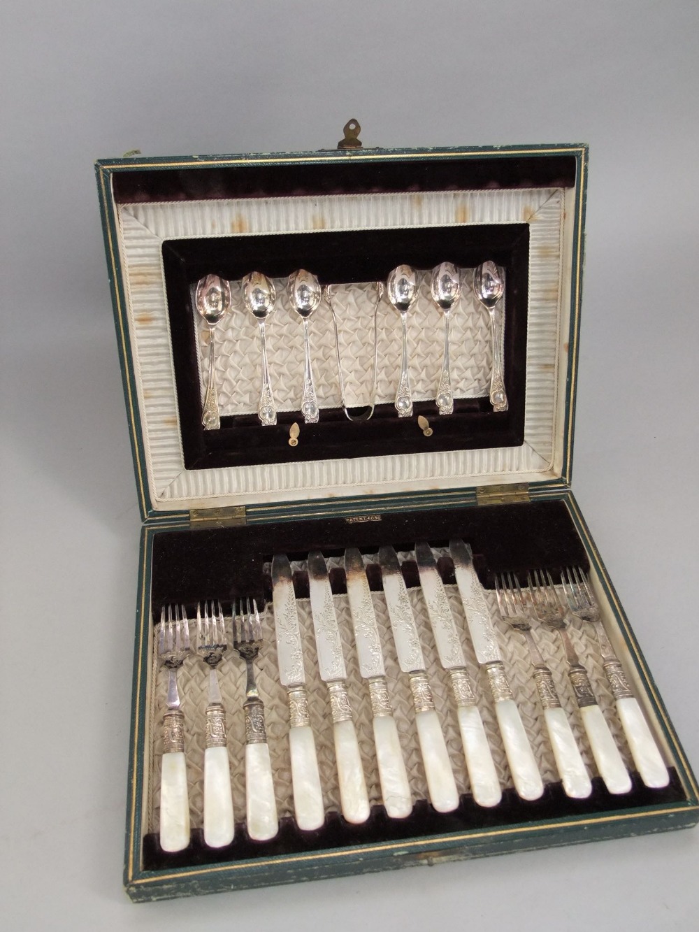 A leather cased canteen of fancy pearl handled flatware to include six knives and forks, together