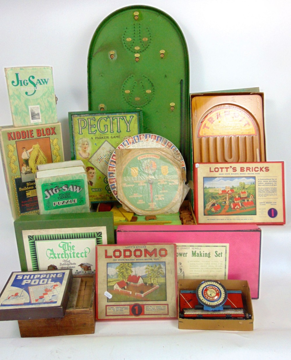 A collection of various vintage games to include a Bagatel board, jigsaws, bricks, etc