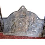 A heavy old cast iron fire back of rectangular arched and pointed form with raised relief armorial