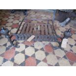 A cast iron fire basket of rectangular form with combined dogs, trellis frieze and urn finial's,