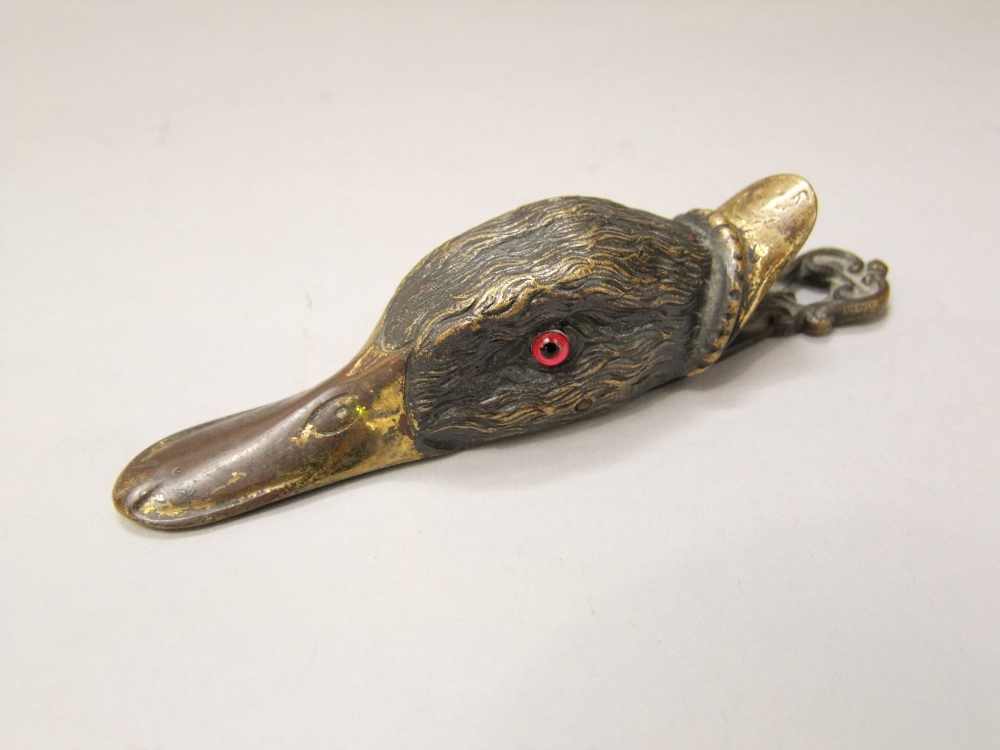 A Victorian cast brass ducks bill paper clip, the well modelled head with glass eyes