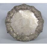 Edwardian silver salver with raised borders embossed with scrolled foliage with engraved plate,